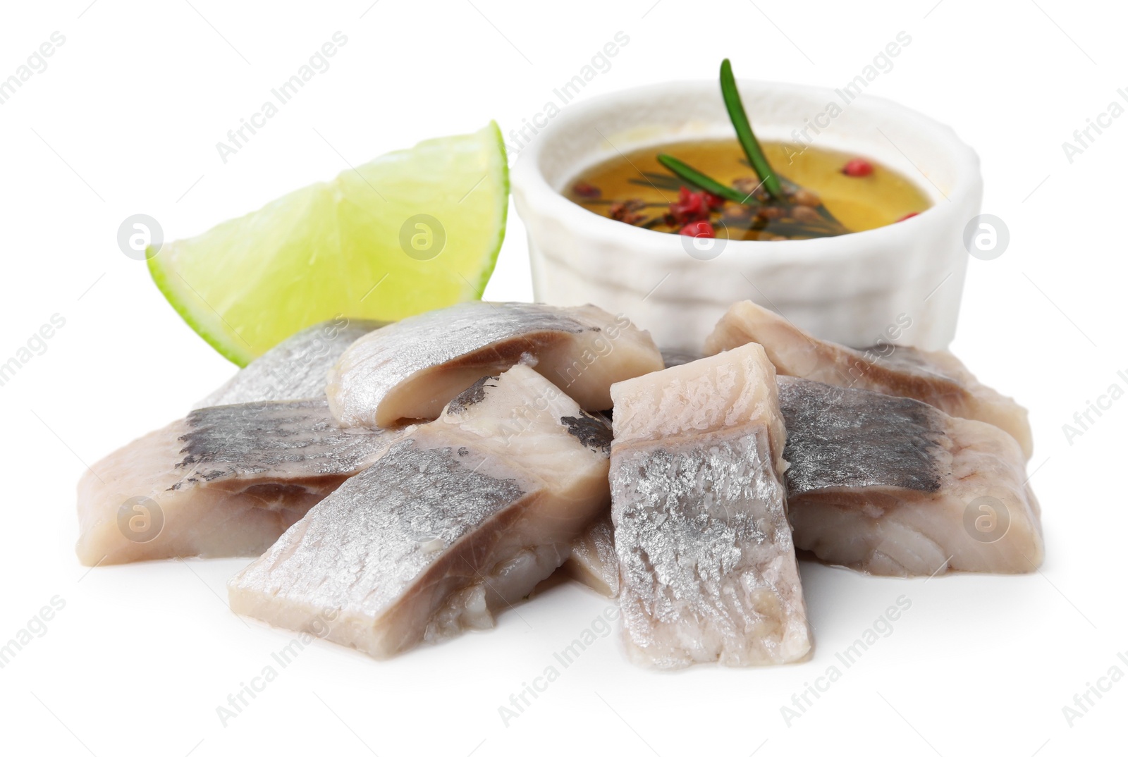 Photo of Pieces of tasty fish, lime and marinade isolated on white