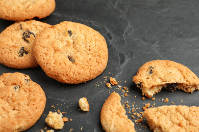Photo of Delicious cookies with raisins on black table, closeup