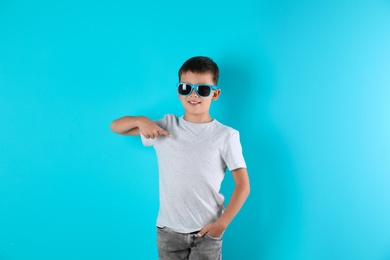Photo of Little boy in t-shirt on color background. Mock-up for design