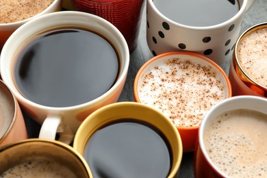 Many cups of different coffees on table, closeup