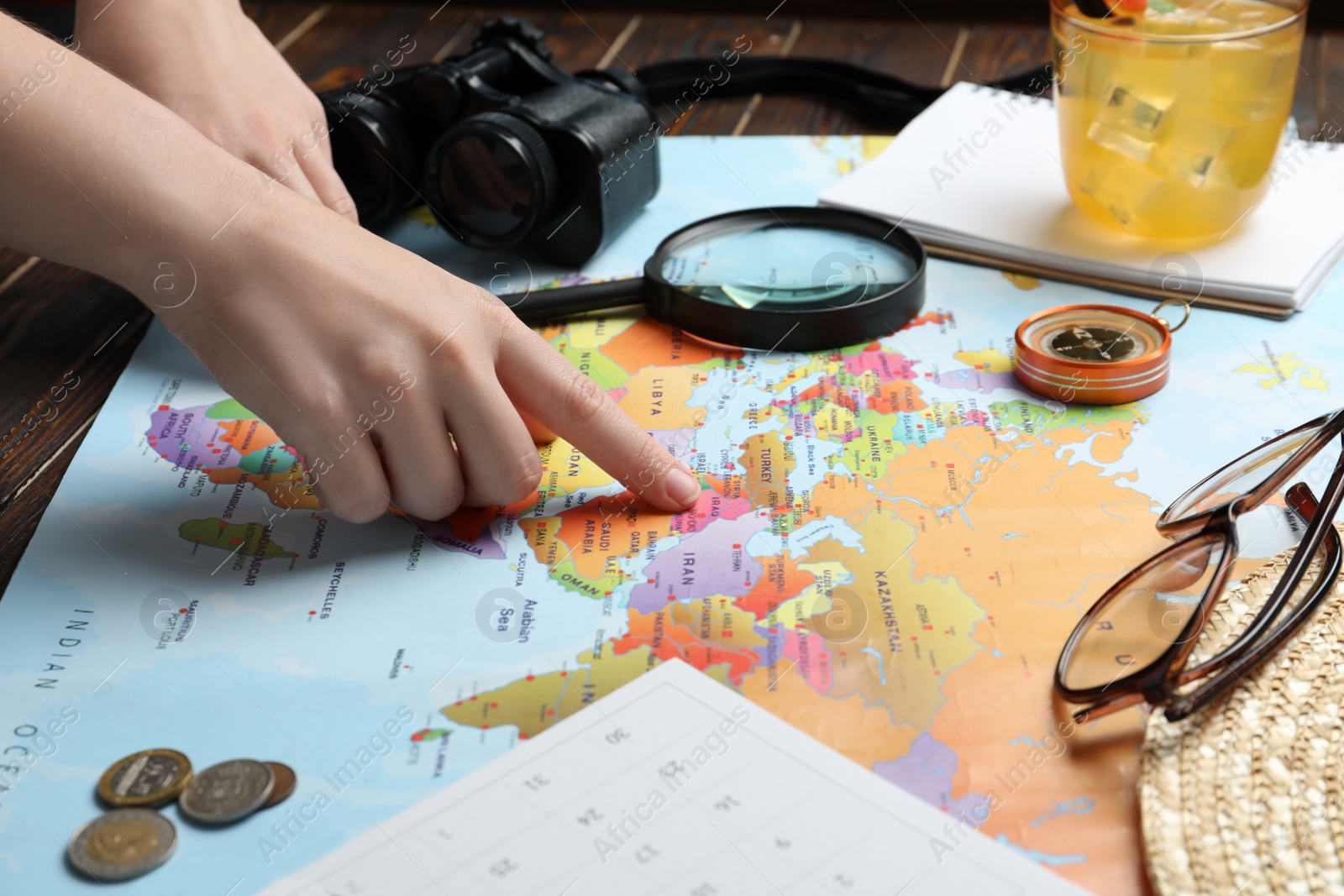 Photo of Woman with world map at table, closeup. Travel during summer vacation
