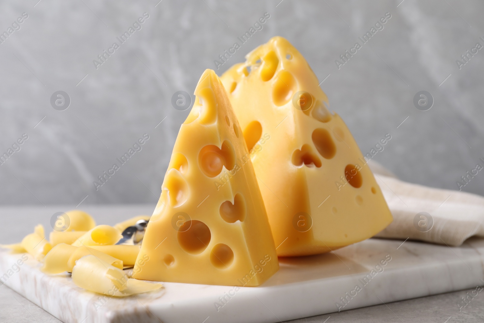 Photo of Tasty fresh cheese on white marble board, closeup