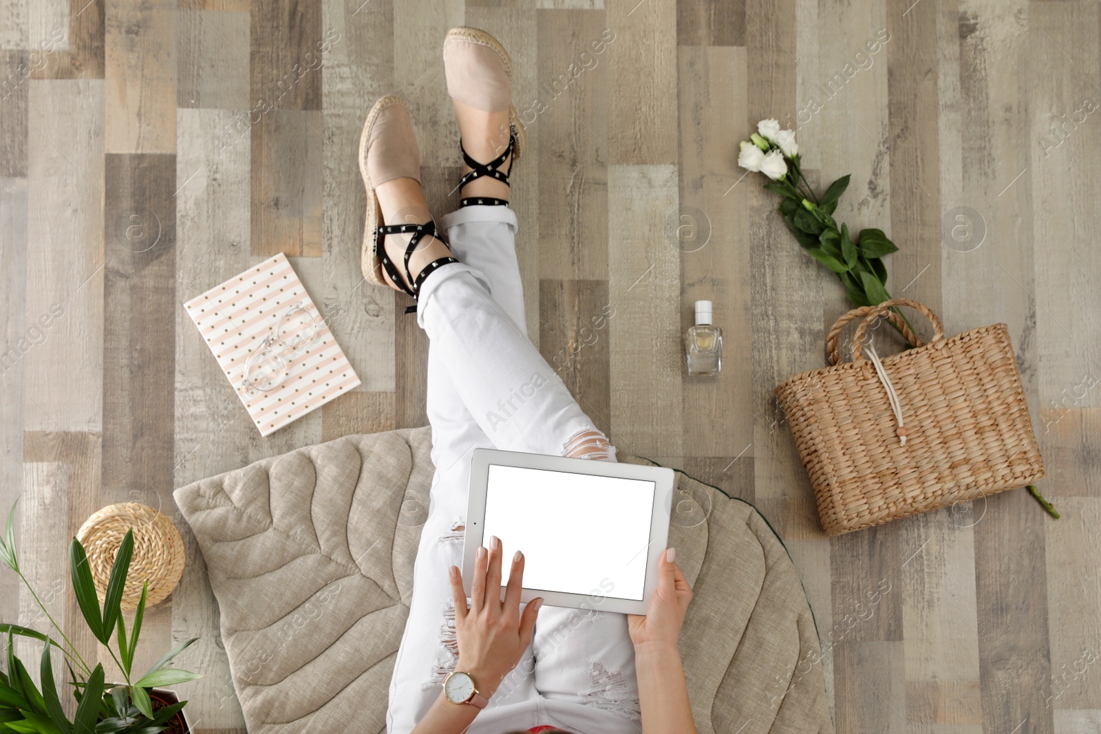 Photo of Woman with tablet sitting on floor, top view. Fashion blogger