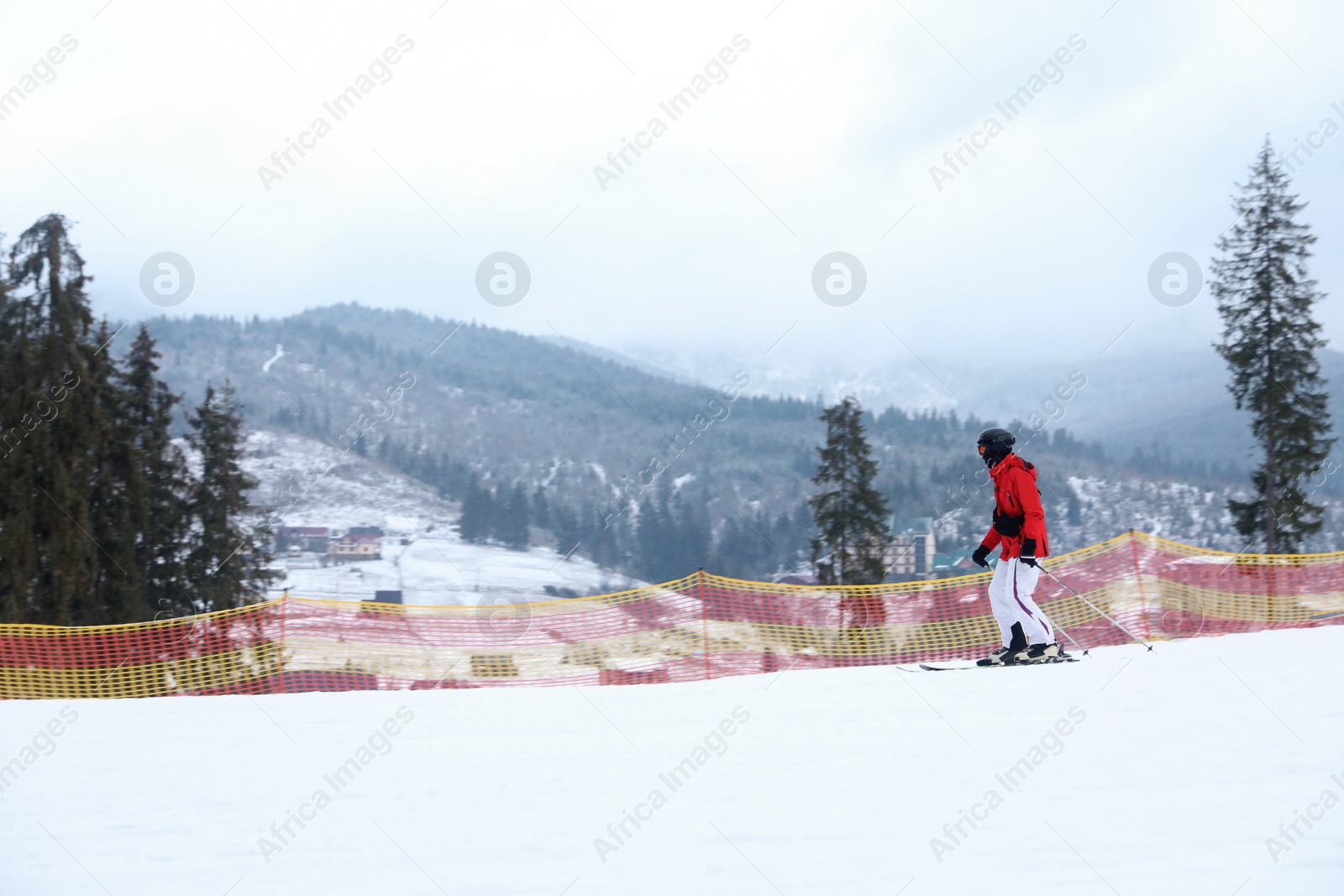 Photo of Skier on slope at resort. Winter vacation