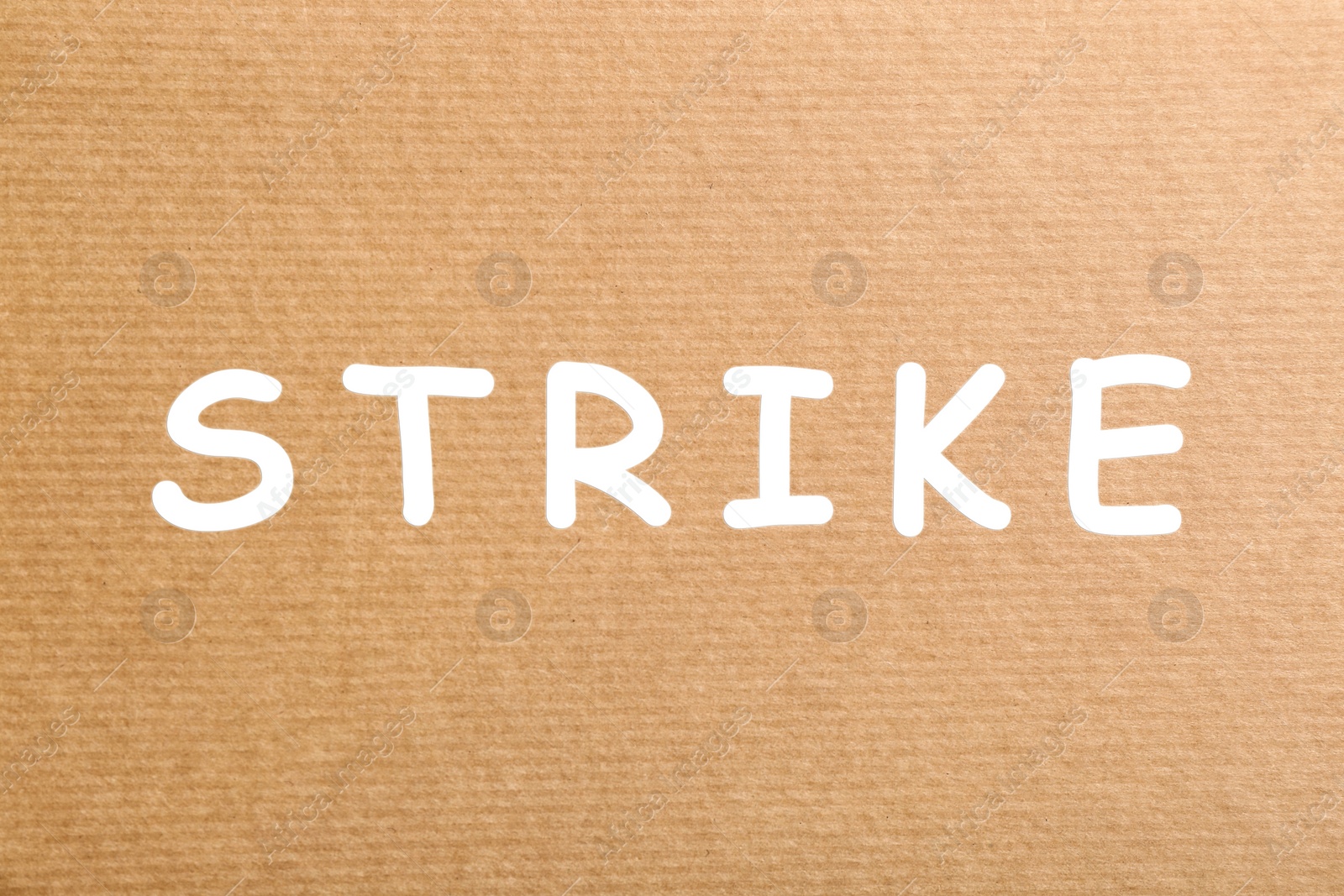 Image of Protest concept. Word Strike on kraft paper