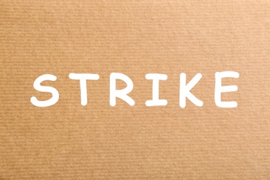 Image of Protest concept. Word Strike on kraft paper