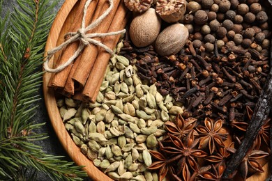 Photo of Different spices, nuts and fir branches on table, flat lay