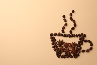 Photo of Cup made with coffee beans and anise stars on beige background, flat lay. Space for text