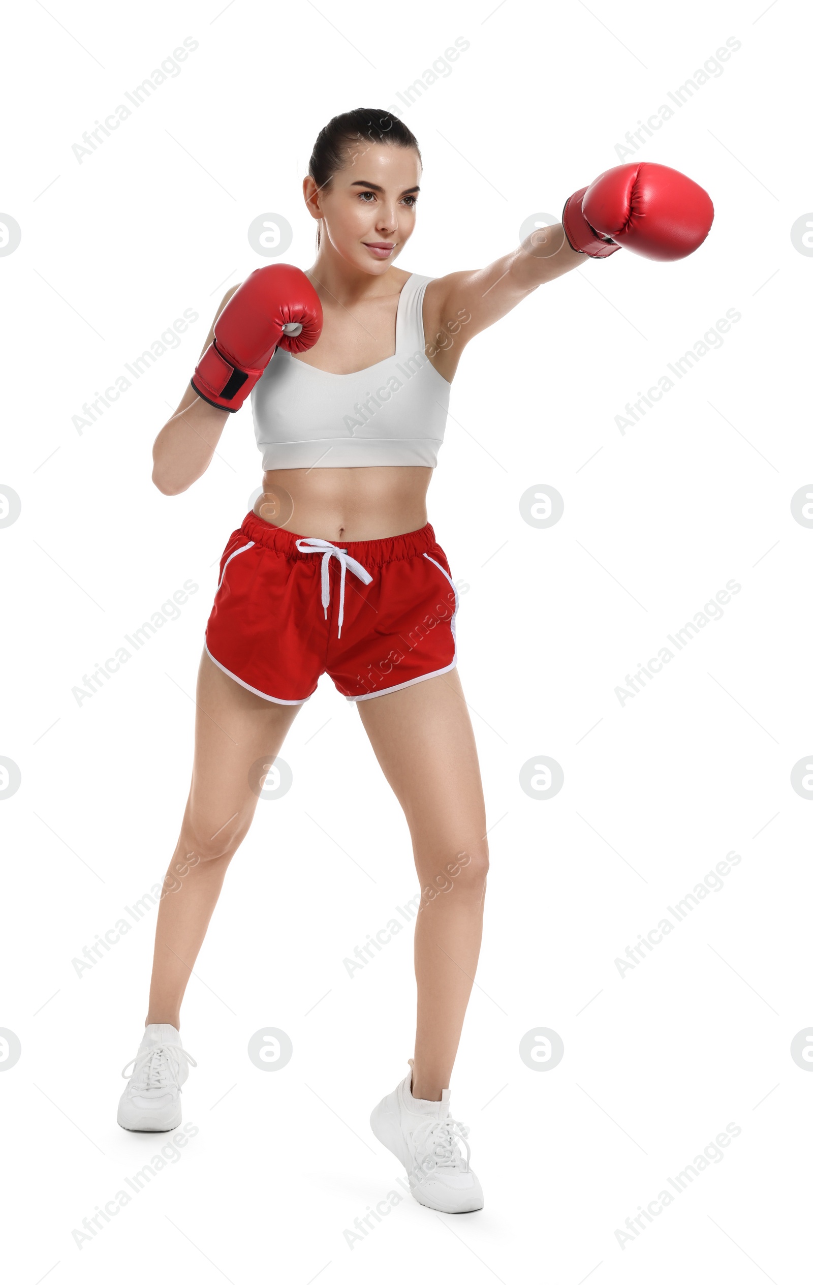 Photo of Beautiful woman in boxing gloves training on white background