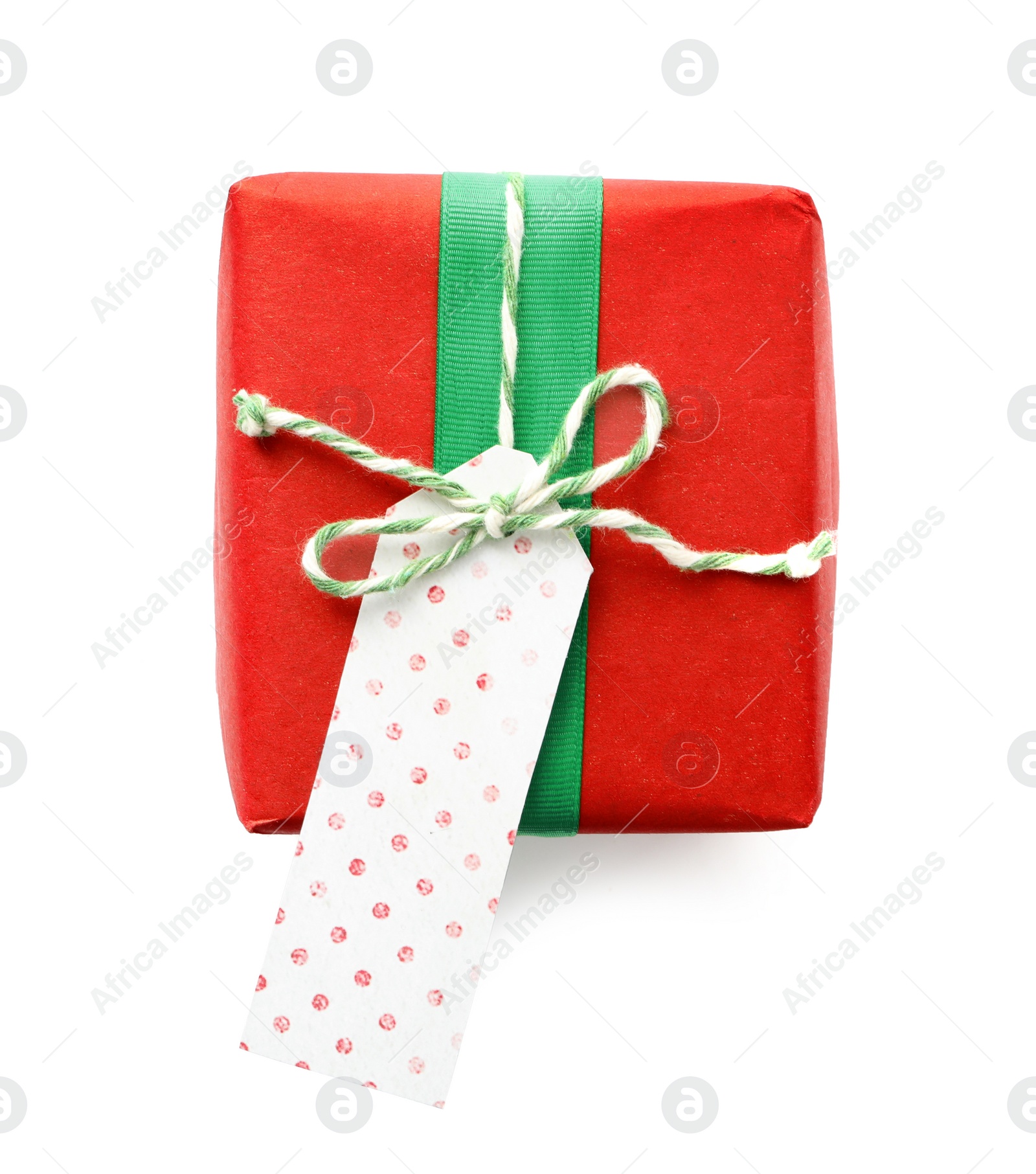 Photo of Christmas gift box with bow and tag isolated on white, top view