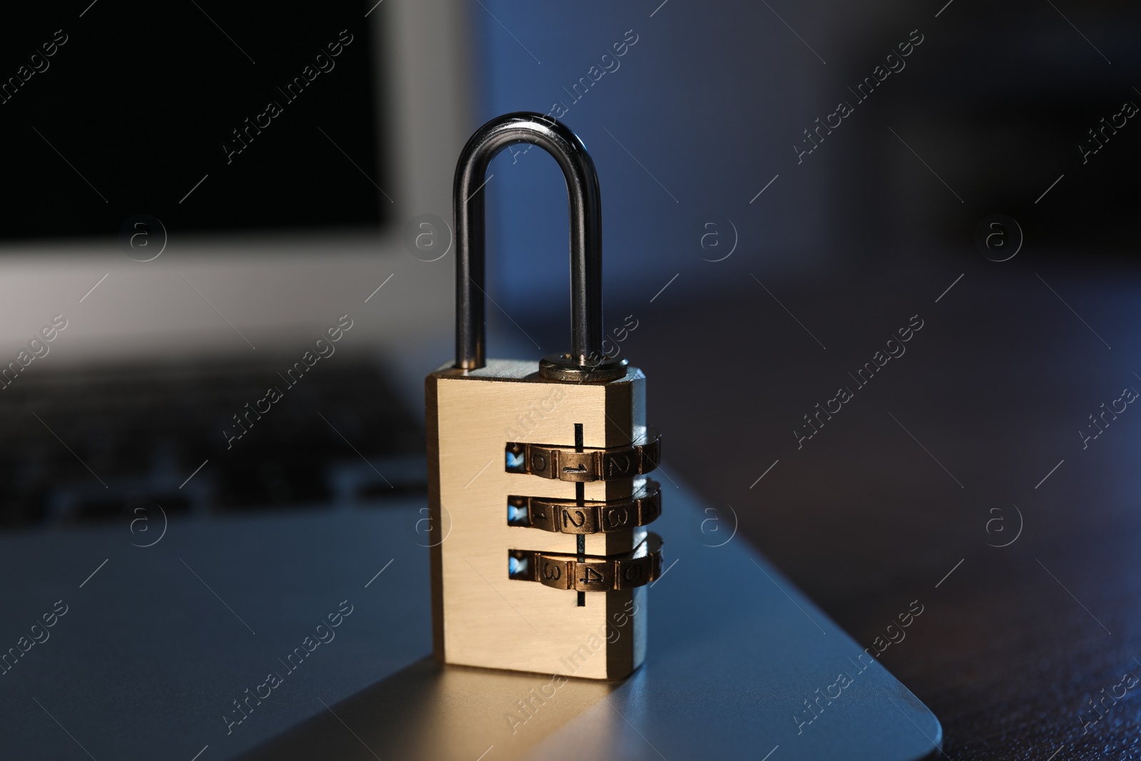 Photo of Cyber security. Laptop with padlock on table, closeup