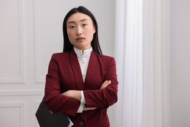 Portrait of notary with crossed arms in office