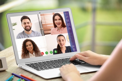 Woman having video chat with team at table, closeup