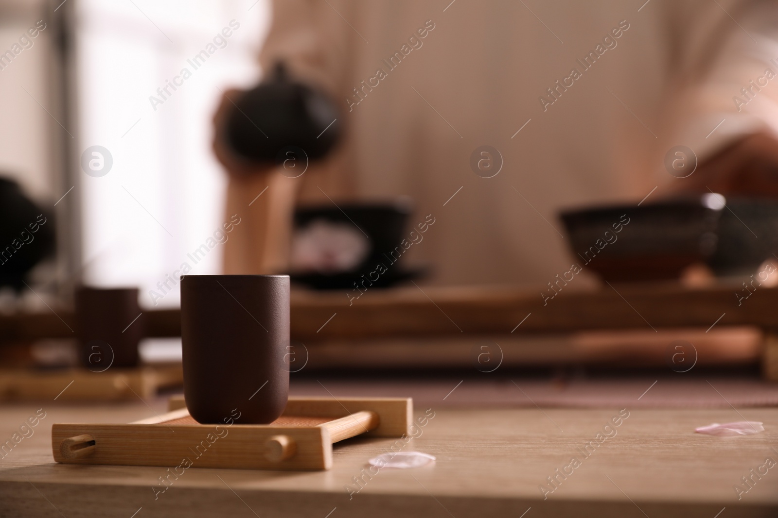 Photo of Cup for traditional tea ceremony on wooden table