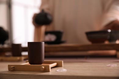 Photo of Cup for traditional tea ceremony on wooden table