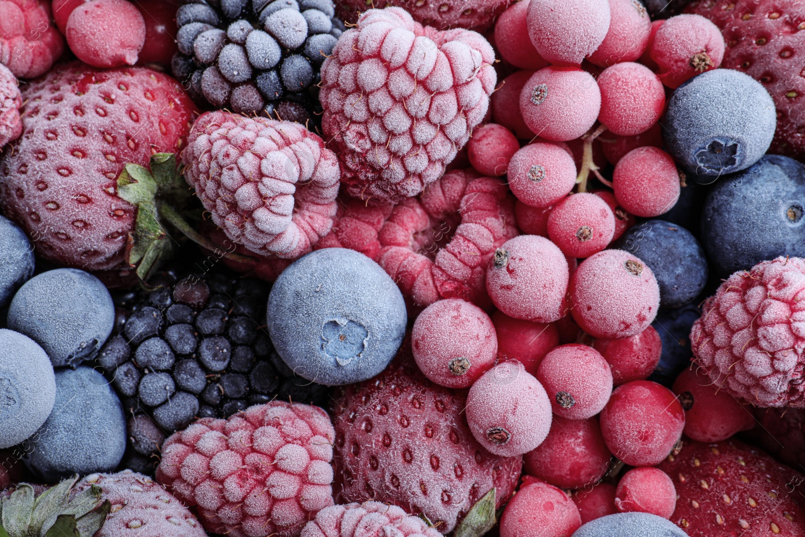 Photo of Mix of different frozen berries as background, top view