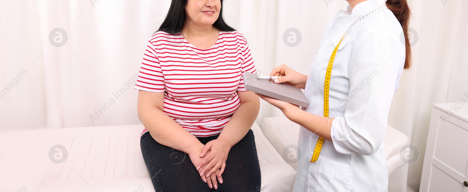 Image of Overweight mature woman consulting with nutritionist in clinic, closeup. Banner design