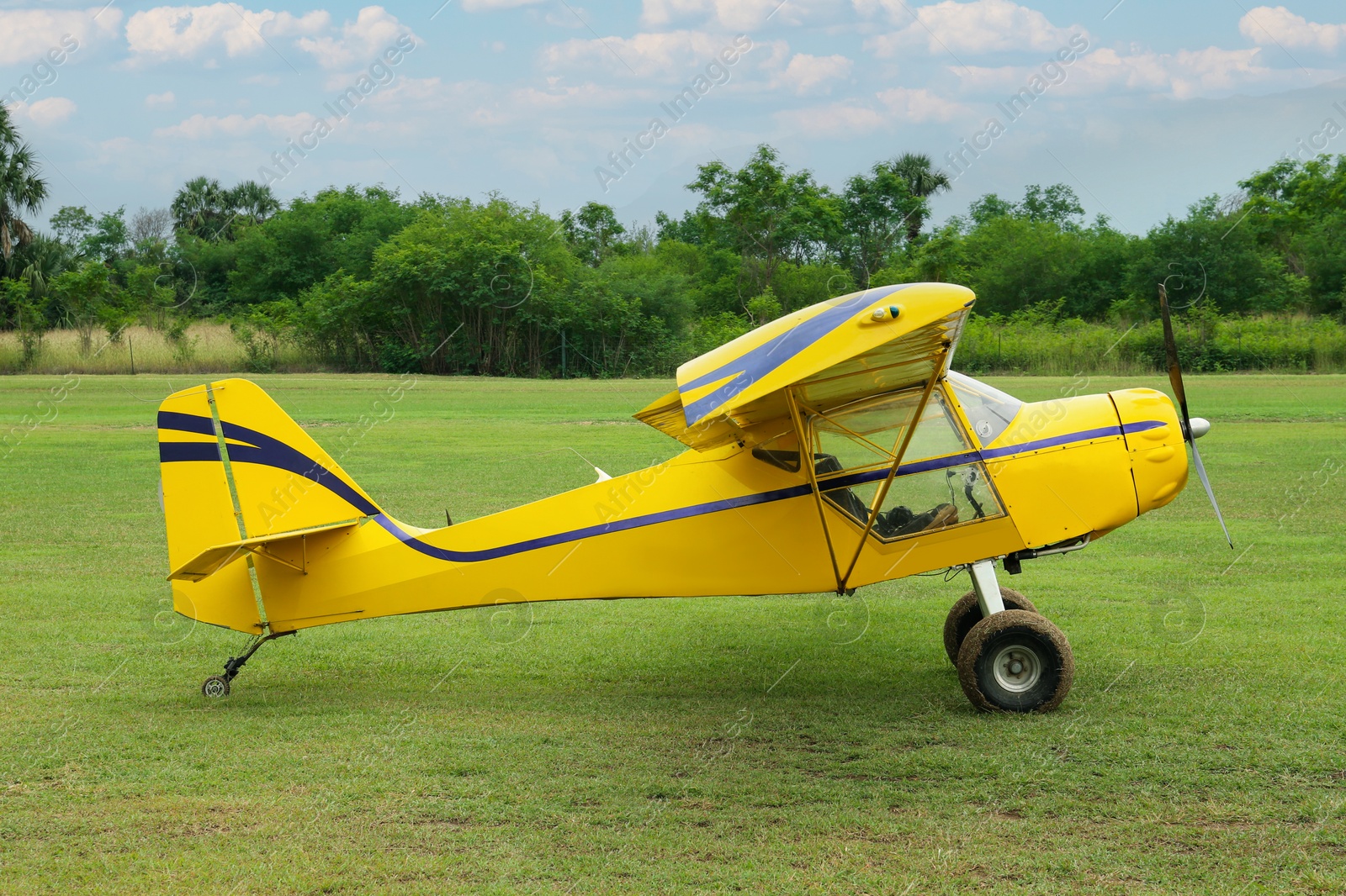 Photo of View of beautiful ultralight airplane in field on autumn day