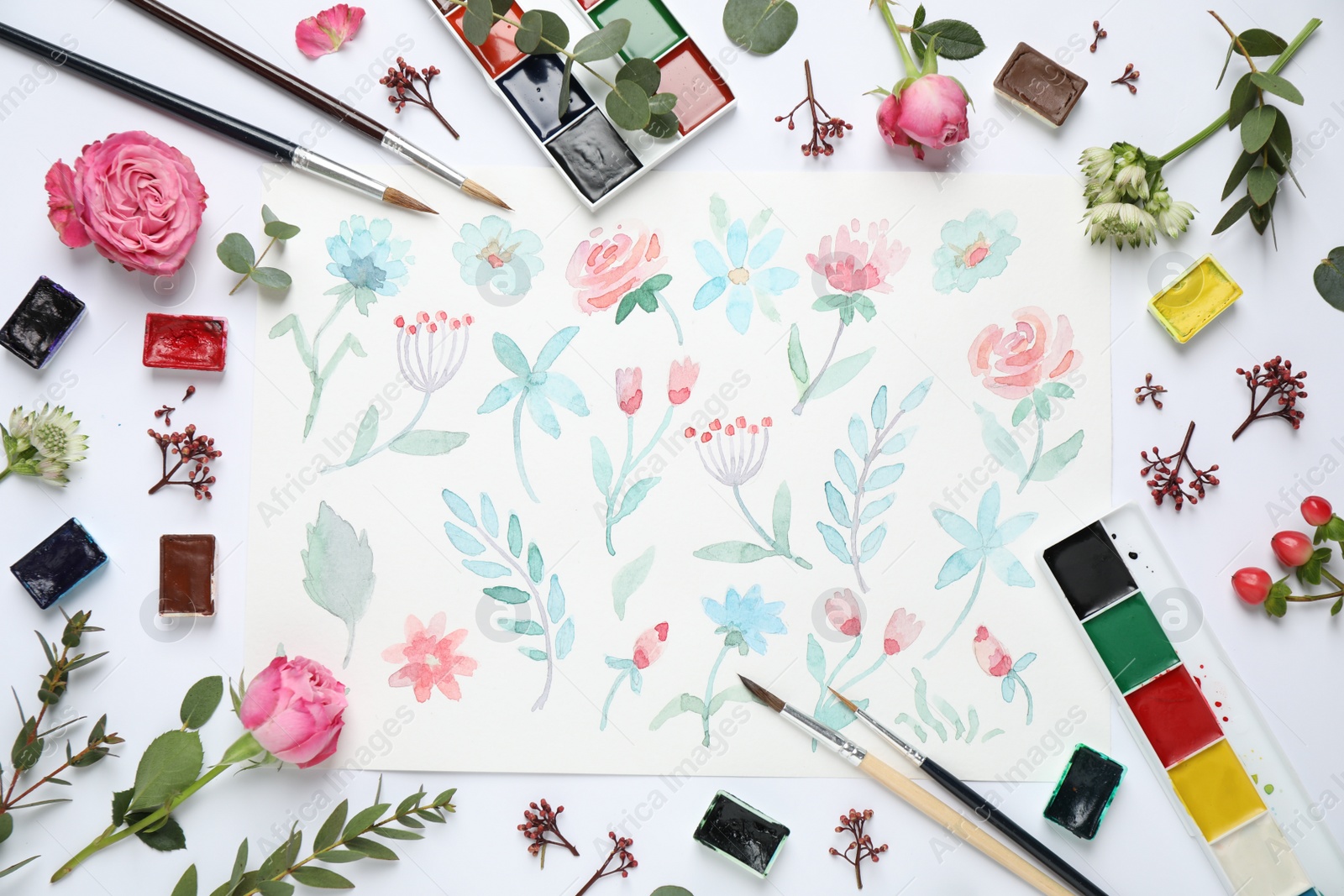 Photo of Flat lay composition with watercolor paints and floral picture on white background