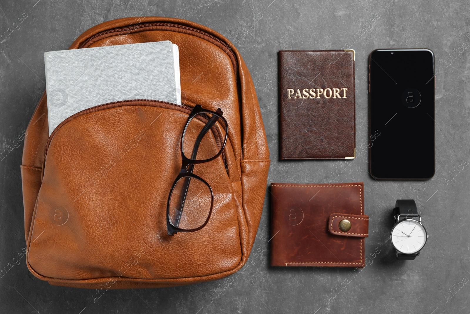 Photo of Stylish urban backpack and different items on black table, flat lay