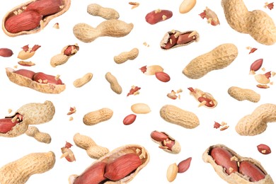 Image of Unpeeled peanuts in air on white background