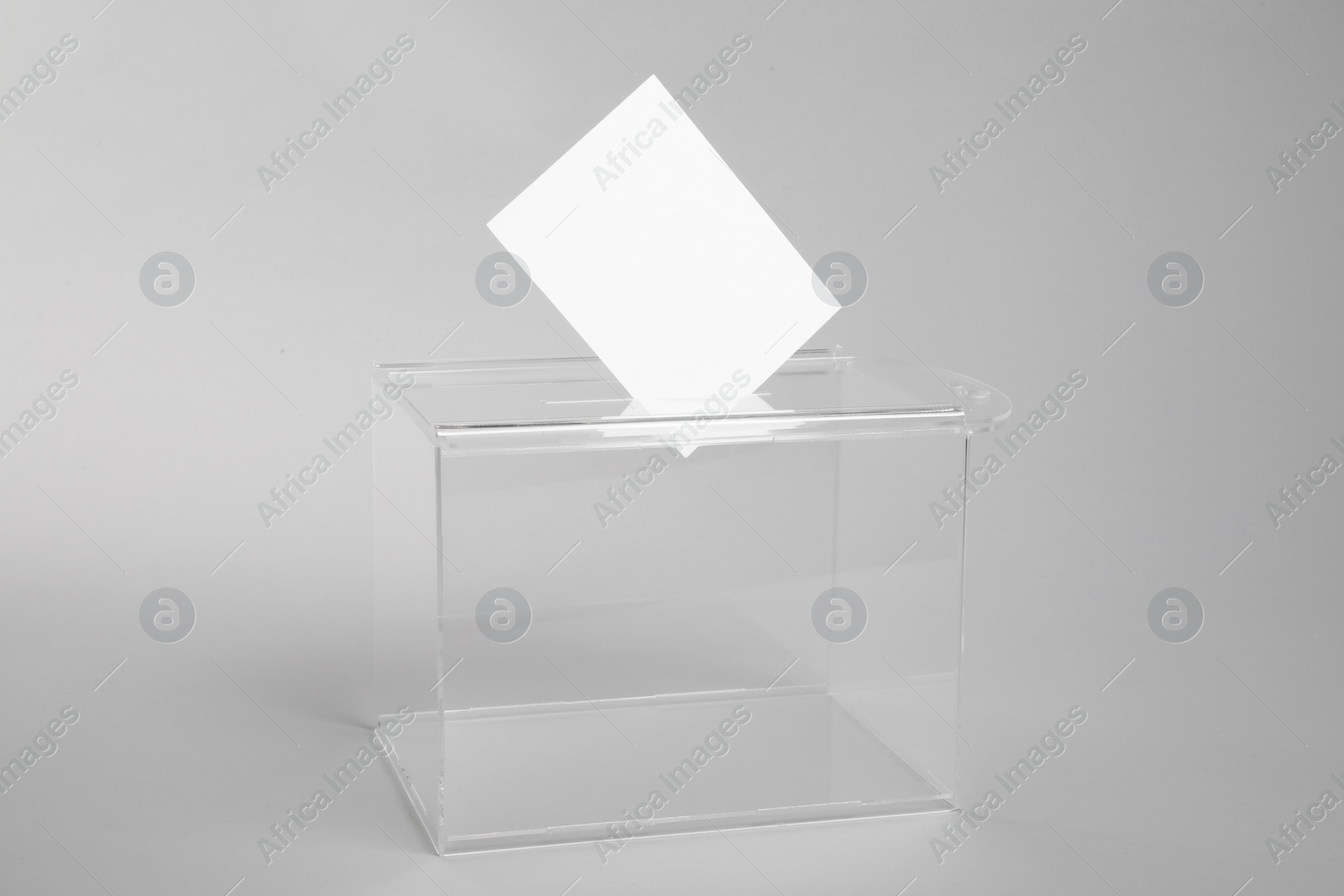 Photo of Ballot box with vote on light grey background. Election time