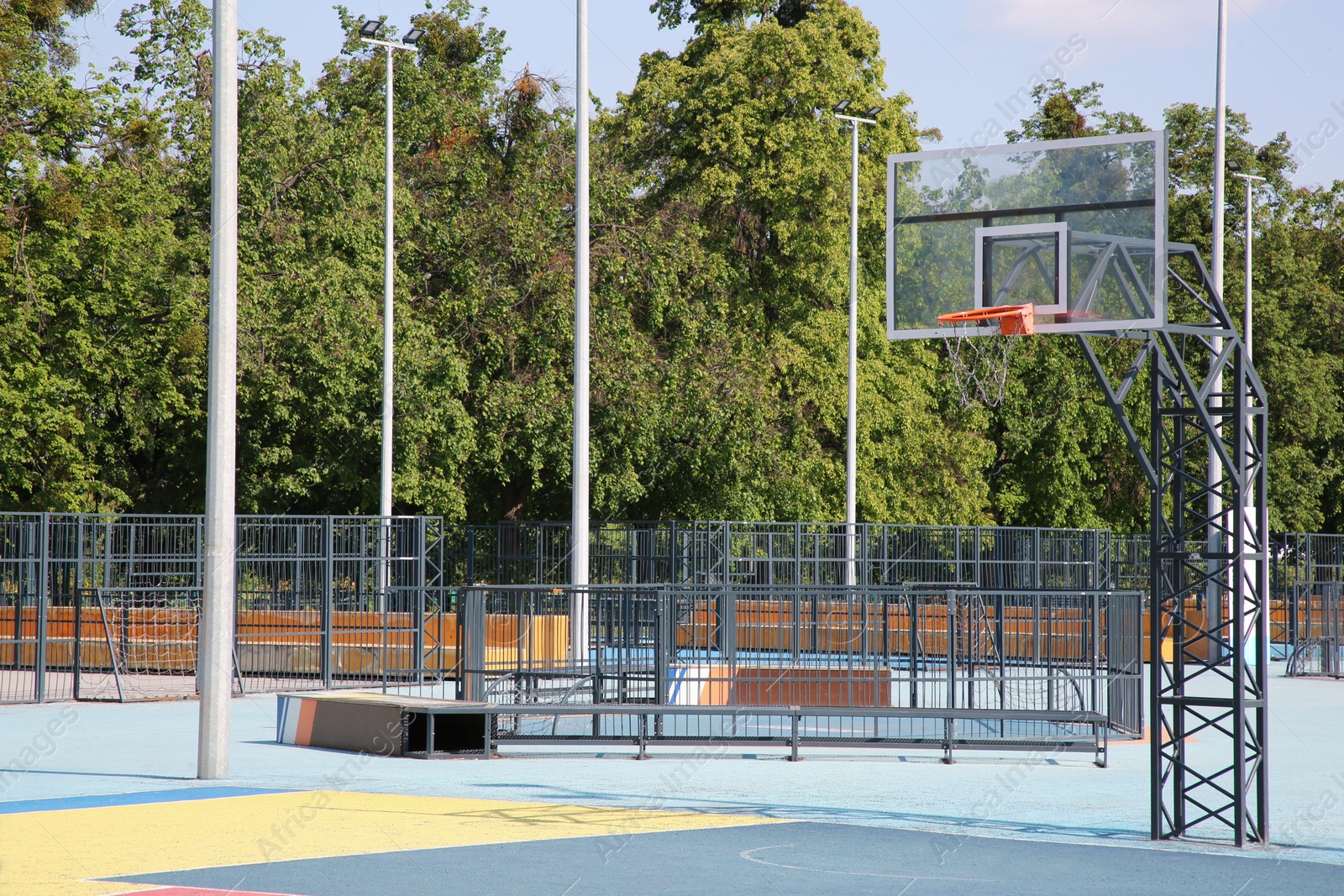 Photo of Empty basketball court with backboard outdoors on sunny day