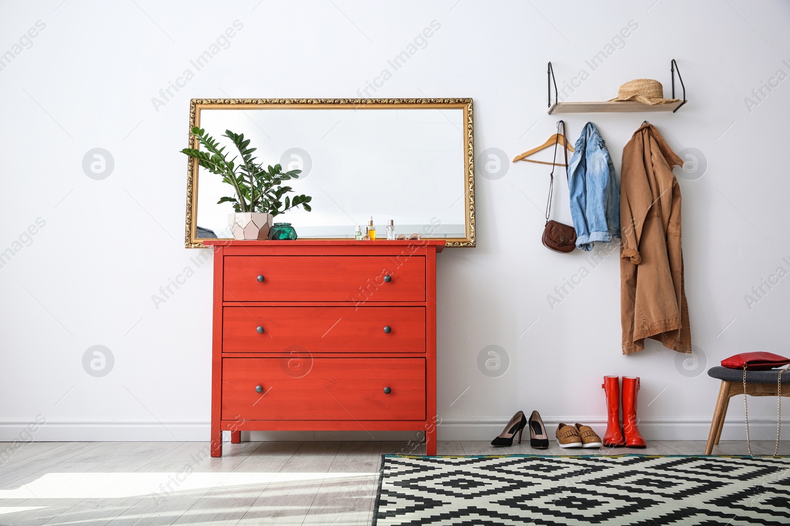 Photo of Stylish hallway interior with mirror and chest of drawers