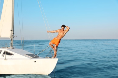 Photo of Young man relaxing on yacht during sea trip