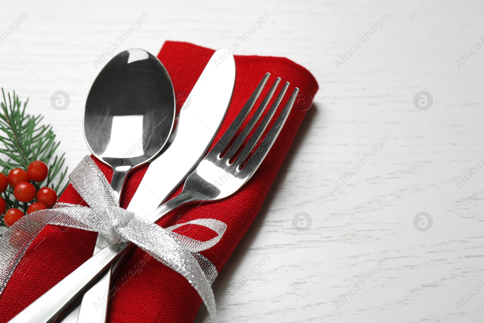 Photo of Cutlery set on white wooden table, closeup