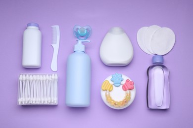 Flat lay composition with baby care products and accessories on lilac background