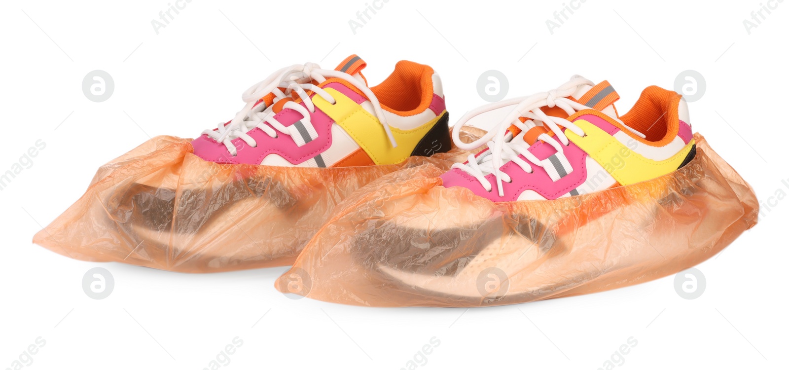 Photo of Sneakers in shoe covers isolated on white