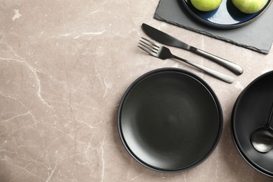 Photo of Set of clean dishware on grey table, flat lay. Space for text