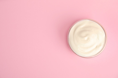 Tasty organic yogurt on pink background, top view. Space for text