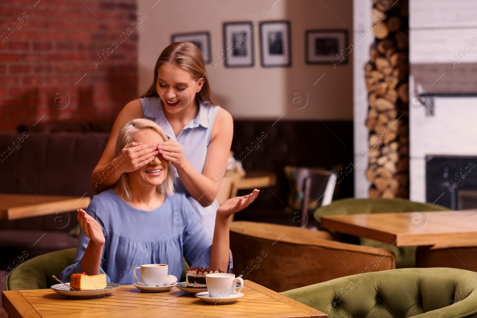 Photo of Mother and her adult daughter spending time together in cafe