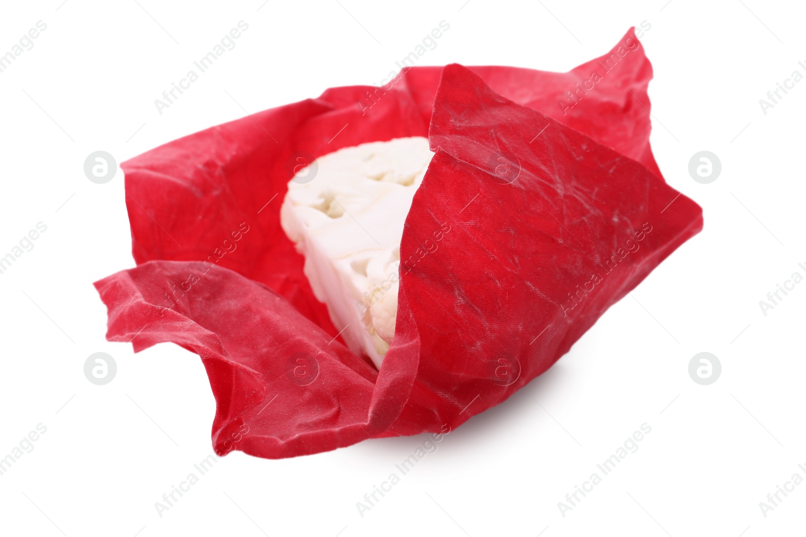 Photo of Cauliflower in red beeswax food wrap on white background