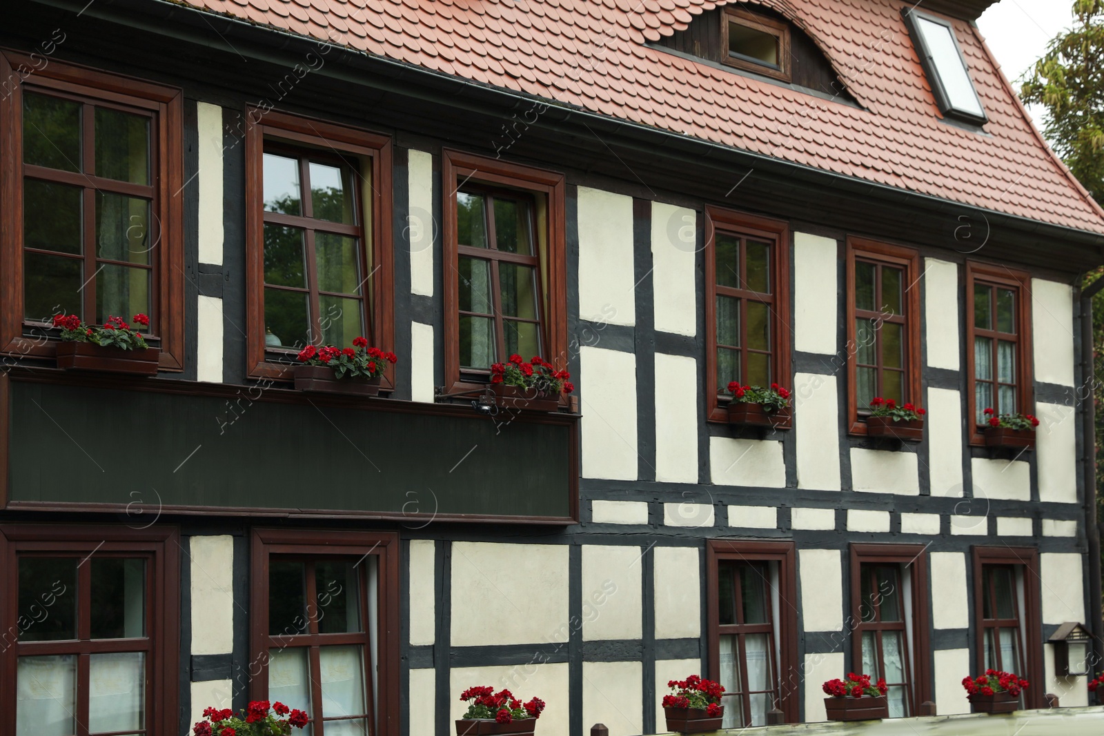 Photo of Stylish house with windows and brown roof