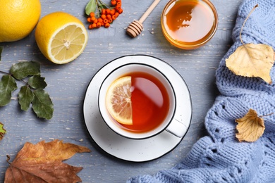 Photo of Flat lay composition with cup of hot drink on grey wooden table. Cozy autumn atmosphere