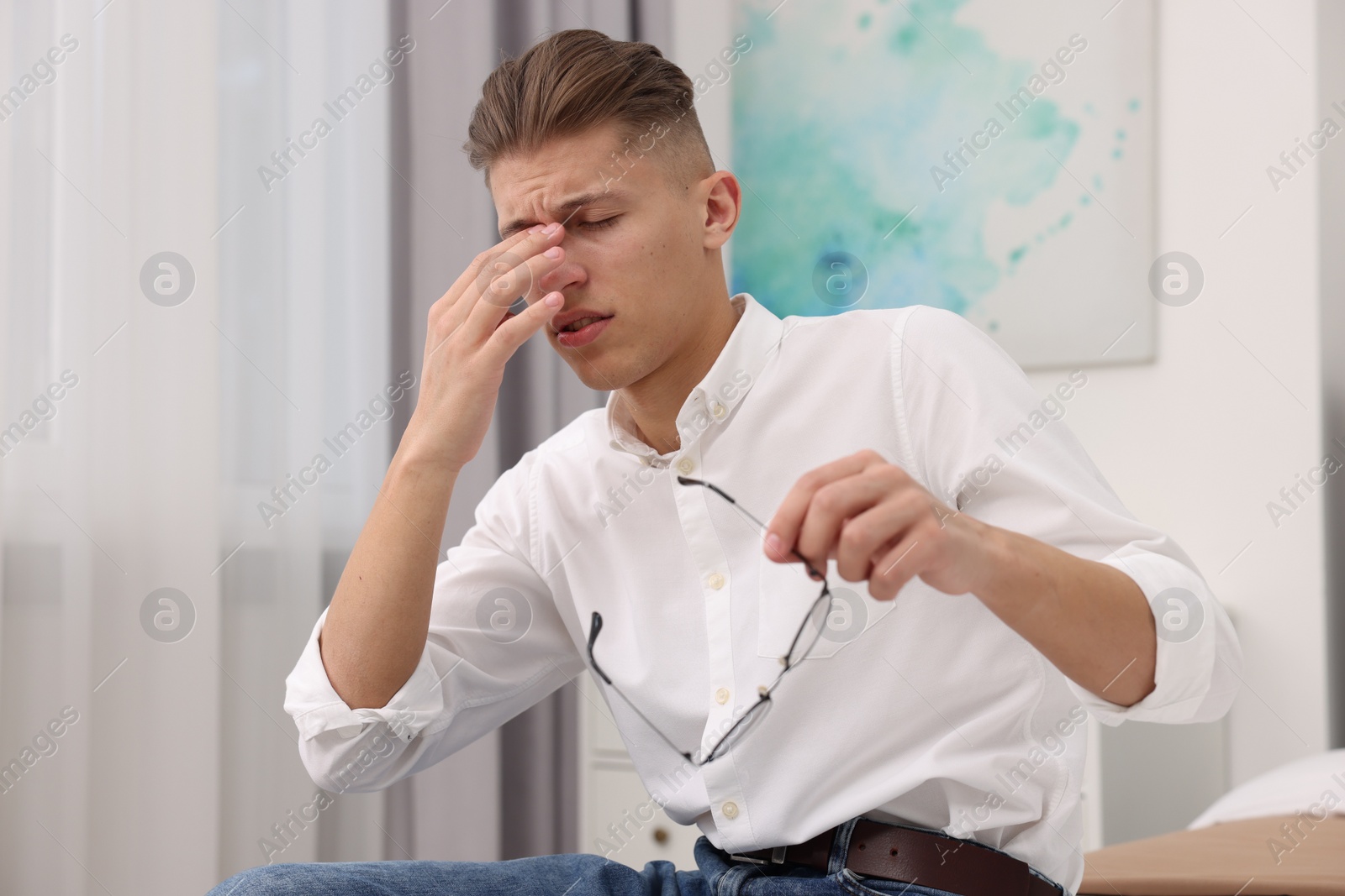 Photo of Overwhelmed man with glasses suffering at home