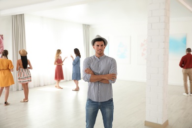 Photo of Thoughtful man at exhibition in art gallery