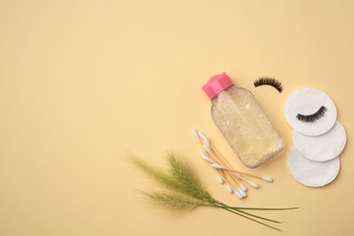 Flat lay composition with makeup remover and spikelets on yellow background. Space for text