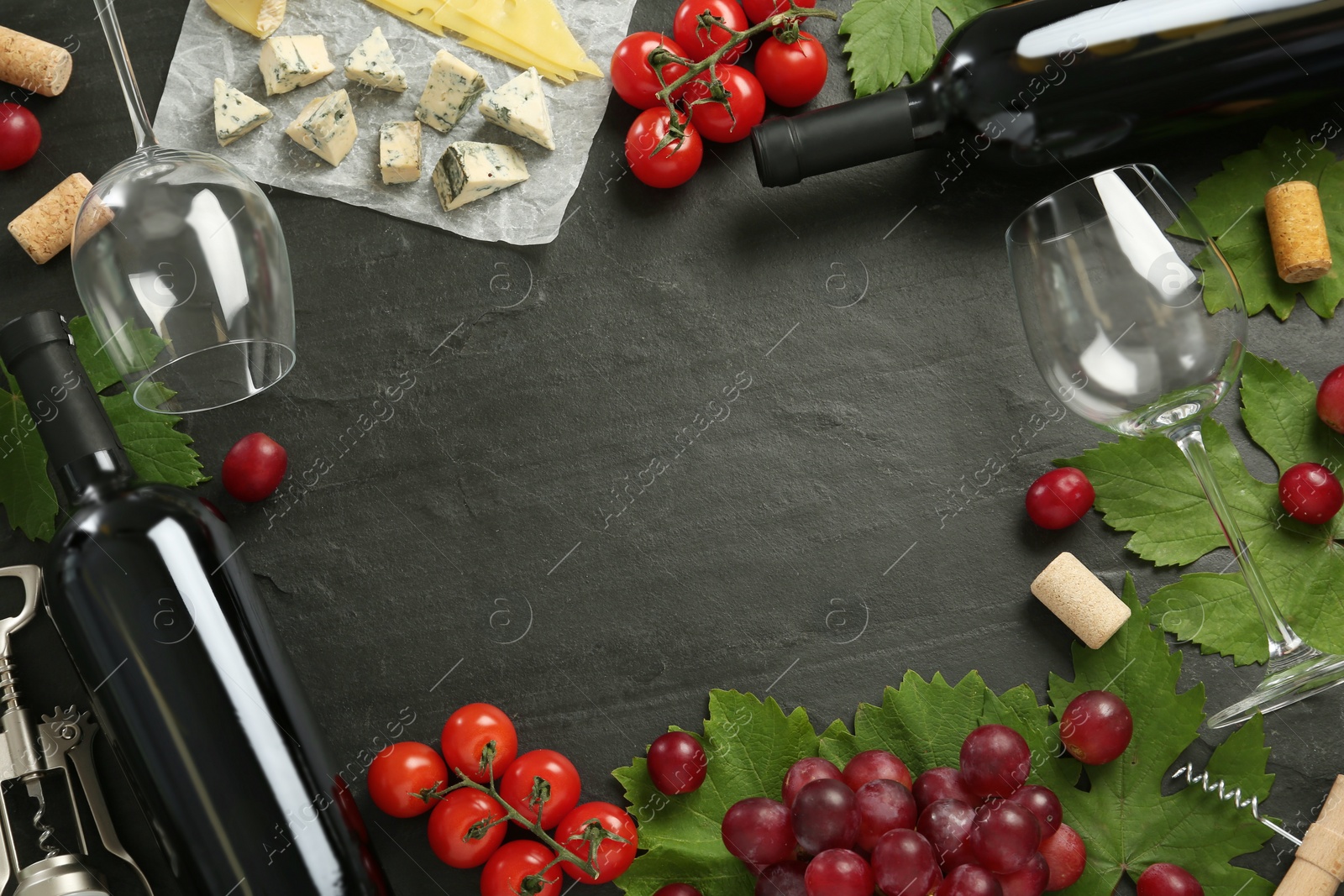 Photo of Frame of tasty red wine and snacks on black table, flat lay. Space for text