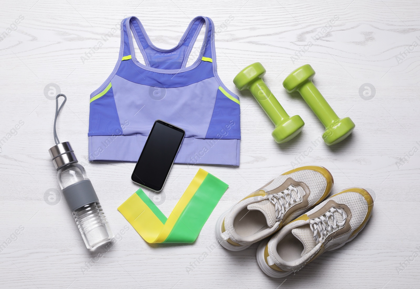 Photo of Flat lay composition with sports equipment on white wooden background