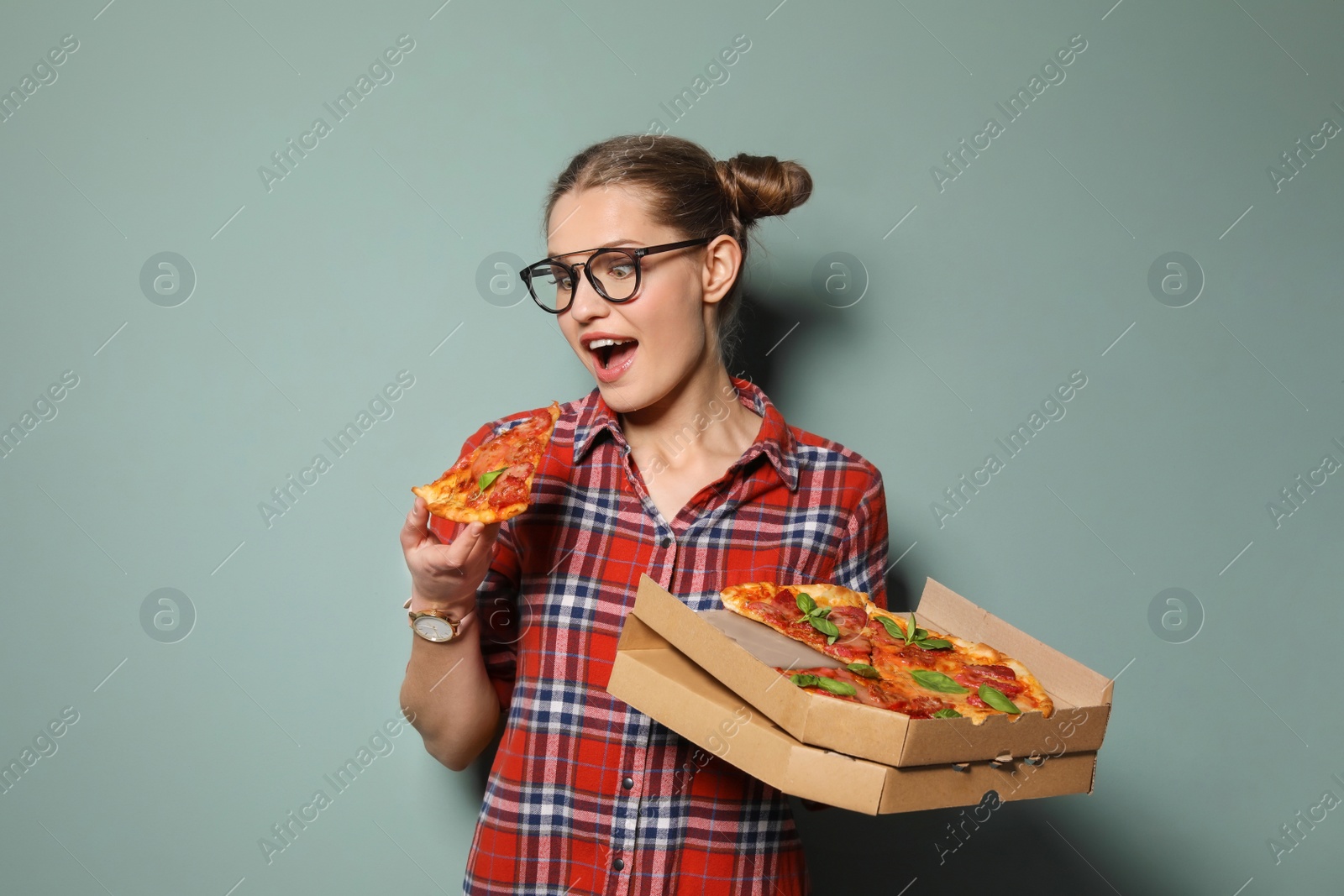 Photo of Attractive young woman with delicious pizza on color background