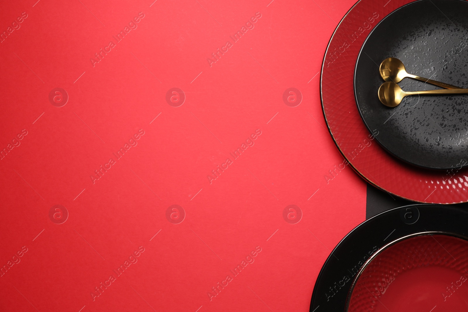 Photo of Stylish table setting with plates and spoons on color background, top view. Space for text