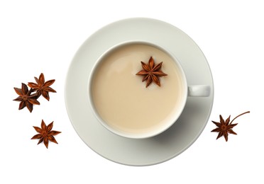 Photo of Cup of tea with milk and anise stars on white table, flat lay