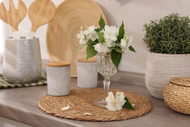 Photo of Beautiful jasmine flowers on wooden table indoors