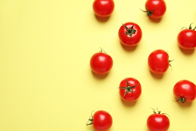 Flat lay composition with cherry tomatoes on color background. Space for text