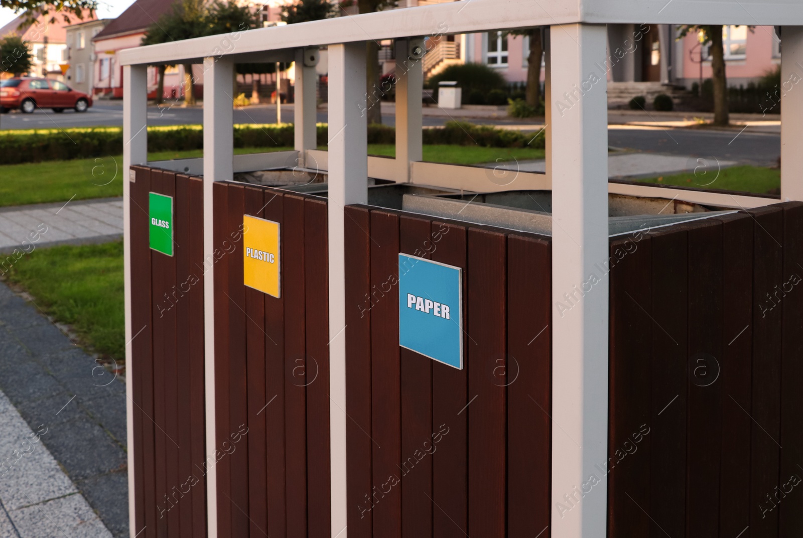 Photo of Different sorting bins for waste recycling outdoors, closeup