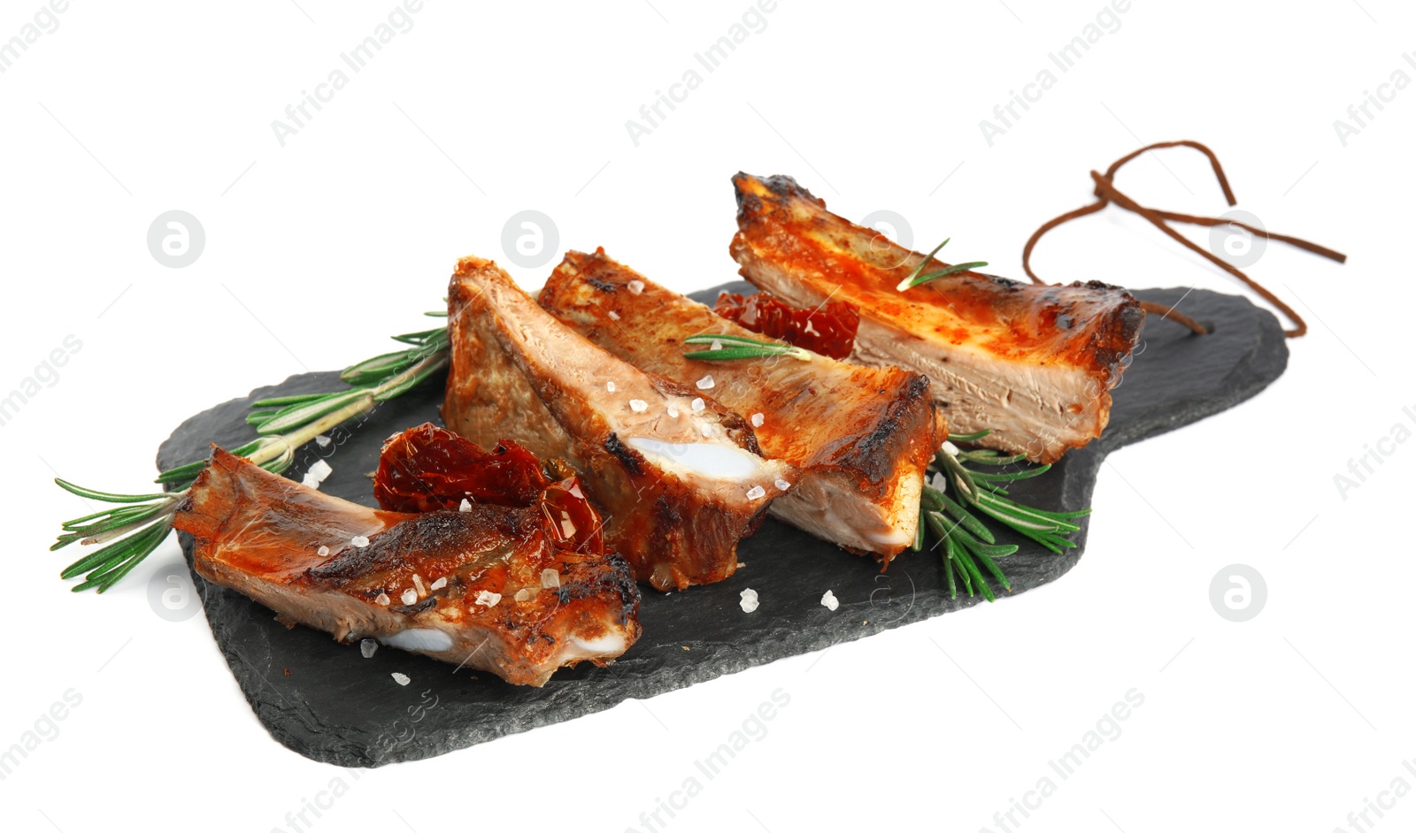 Photo of Slate plate with tasty grilled ribs isolated on white